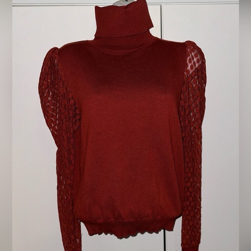 Orange turtleneck sweater with lace sleeves